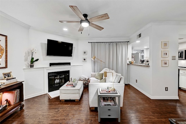 living room with crown molding, ceiling fan, and dark hardwood / wood-style flooring