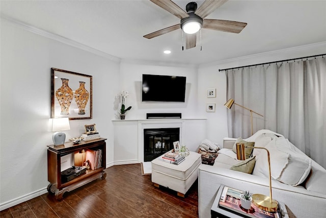 living room featuring ceiling fan, ornamental molding, and dark hardwood / wood-style floors