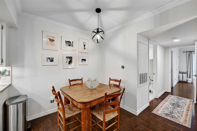 dining room with crown molding and dark hardwood / wood-style flooring