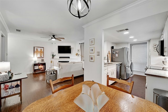 3840 Far W Blvd Unit 101, Austin, TX 78731 - dining area with dark wood-type flooring, ceiling fan, and ornamental molding