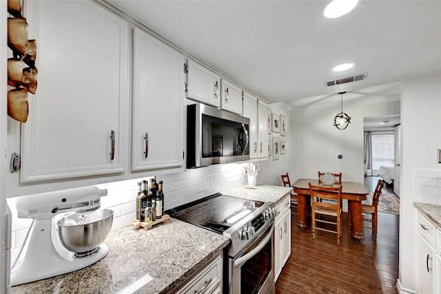 3840 Far W Blvd Unit 101, Austin, TX 78731 - kitchen featuring white cabinetry, appliances with stainless steel finishes, dark hardwood / wood-style flooring, and decorative light fixtures
