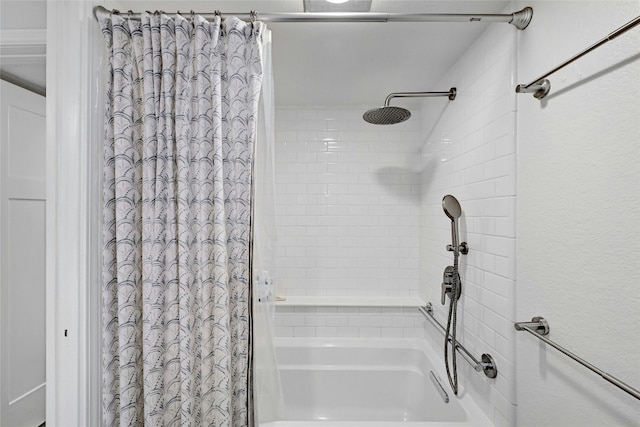 bathroom with shower / bath combo with shower curtain