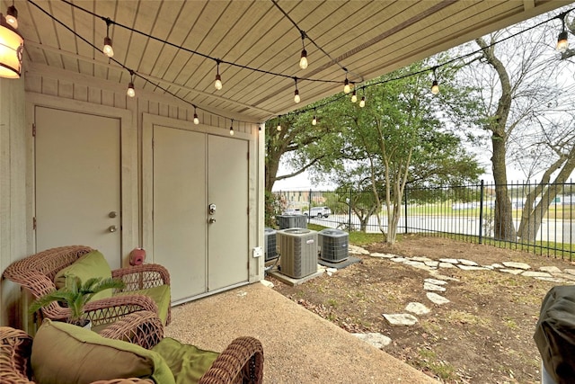 view of patio / terrace with a water view and central AC