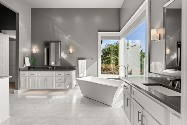 bathroom with a tub to relax in and vanity