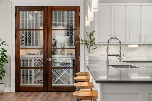 821 Laughing Dog Ct, Leander, TX 78641 - wine room with a sink and wood finished floors