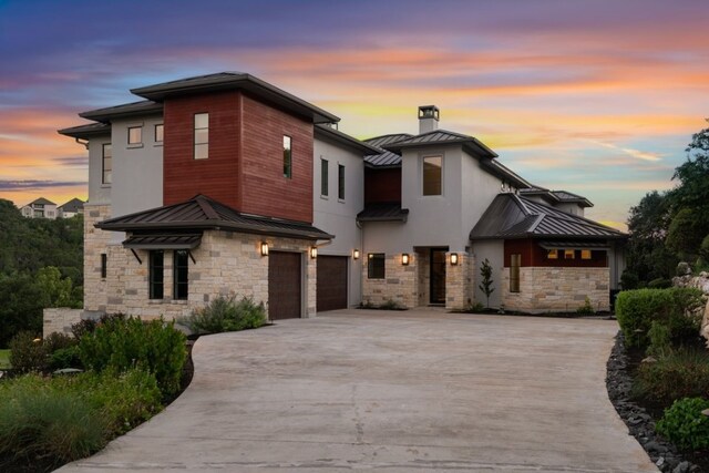 821 Laughing Dog Ct, Leander, TX 78641 - contemporary house with a standing seam roof, stone siding, and a metal roof