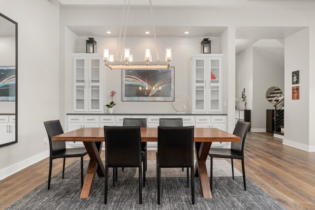821 Laughing Dog Ct, Leander, TX 78641 - dining area featuring a chandelier, stairs, wood finished floors, and recessed lighting