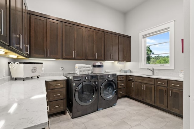 washroom with cabinets, sink, and independent washer and dryer