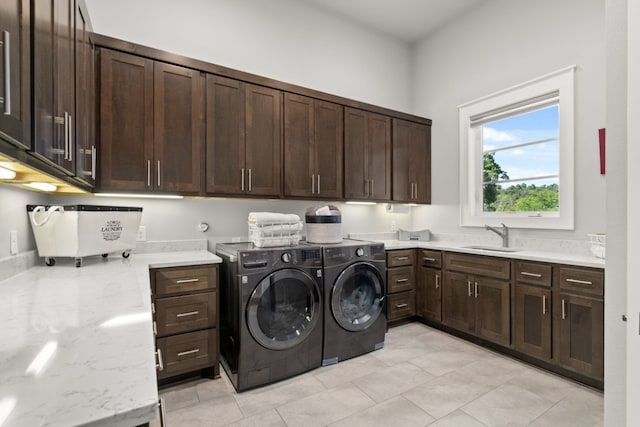 821 Laughing Dog Ct, Leander, TX 78641 - laundry room featuring cabinet space, independent washer and dryer, and light tile patterned flooring