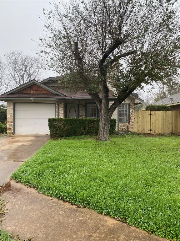 view of front of property featuring a garage and a front yard