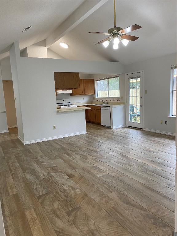 kitchen with dishwasher, kitchen peninsula, hardwood / wood-style flooring, ceiling fan, and stove