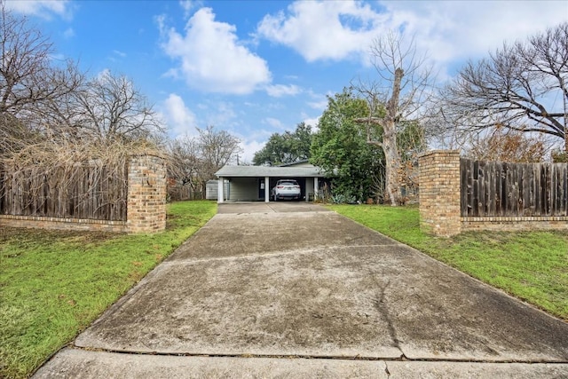 view of front of home with a carport and a front lawn