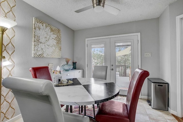 tiled dining room featuring ceiling fan, a textured ceiling, and french doors