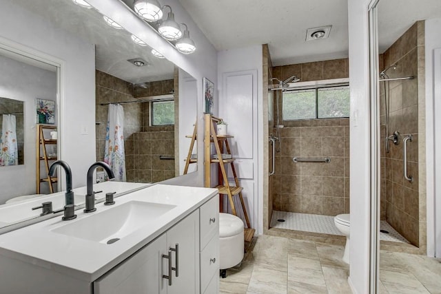 bathroom with a shower with curtain, vanity, and toilet