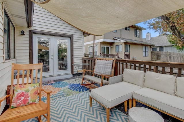 wooden terrace with an outdoor hangout area and french doors