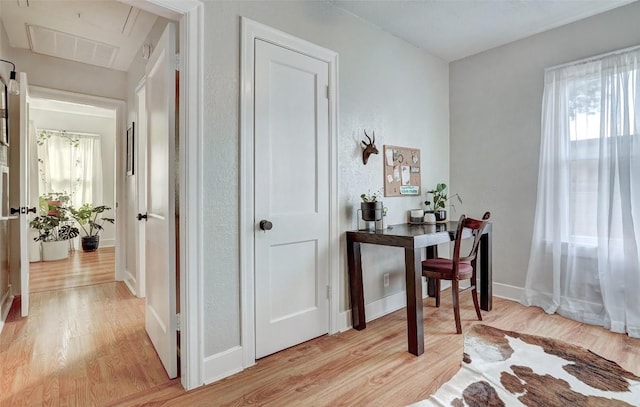 hallway with light hardwood / wood-style flooring