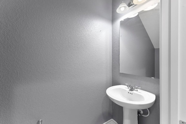 bathroom featuring a textured wall