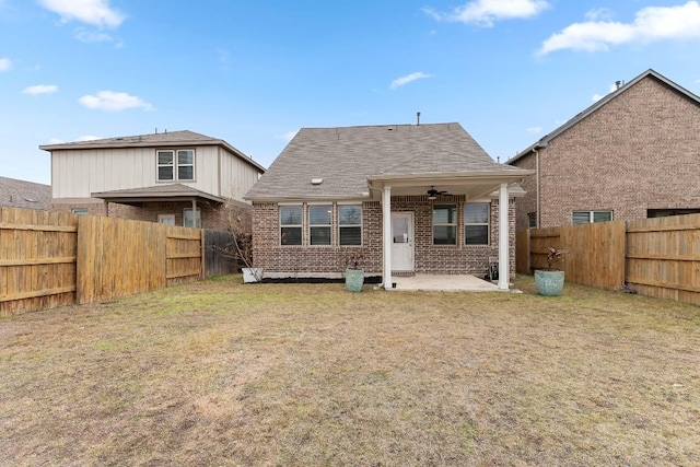 rear view of property with brick siding, ceiling fan, a patio, and a fenced backyard