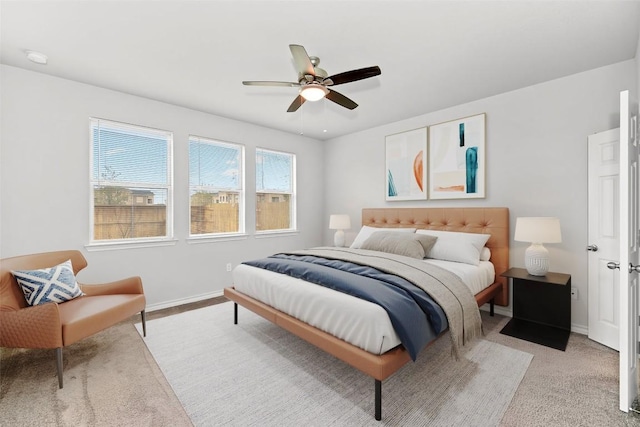 bedroom with a ceiling fan and baseboards