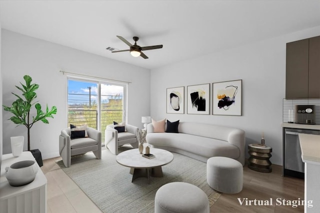 living room with ceiling fan and light hardwood / wood-style flooring