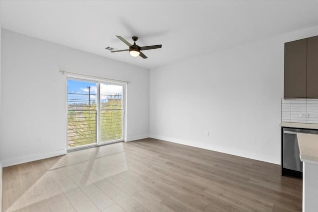 unfurnished living room featuring ceiling fan and light hardwood / wood-style floors