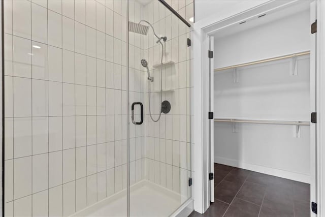 bathroom featuring tile patterned floors and a shower with door