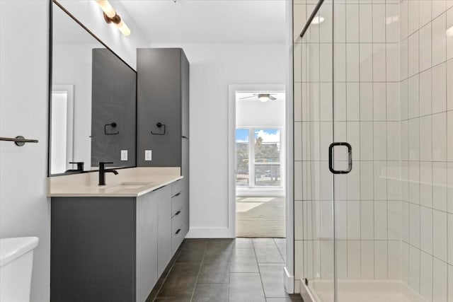 bathroom with vanity, tile patterned flooring, toilet, and walk in shower