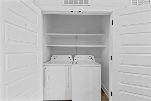 laundry room with separate washer and dryer