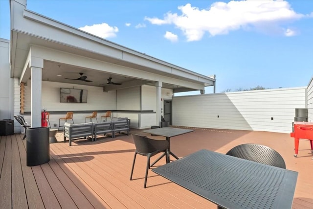 deck with ceiling fan and an outdoor living space