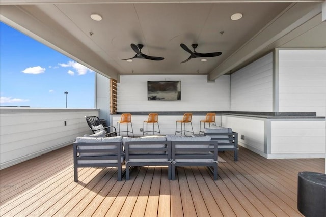 wooden terrace featuring an outdoor living space and ceiling fan