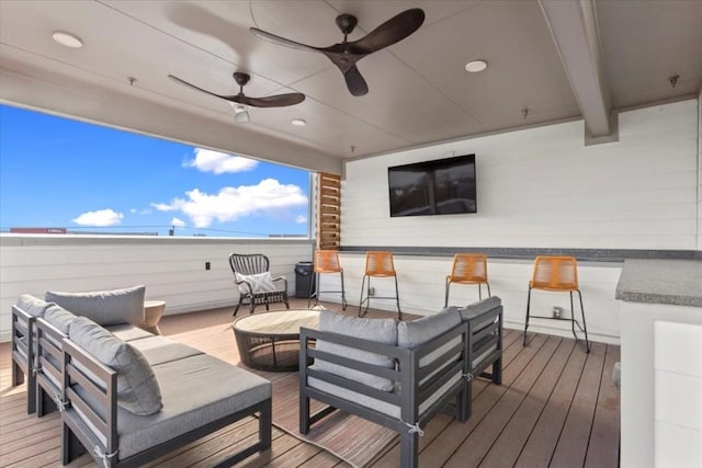 deck featuring ceiling fan and an outdoor living space