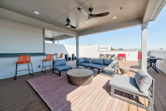 deck with ceiling fan and an outdoor living space