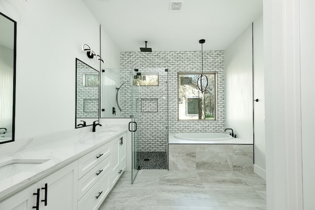 bathroom featuring vanity and separate shower and tub