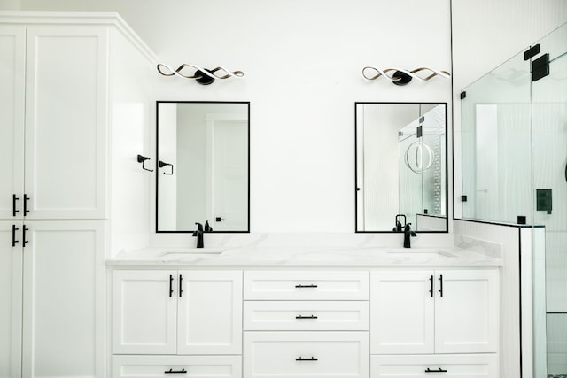 bathroom featuring vanity and a shower with shower door