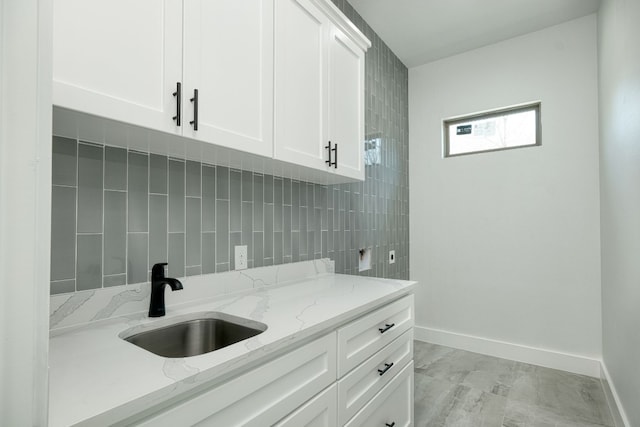 clothes washing area with sink, cabinets, and hookup for an electric dryer