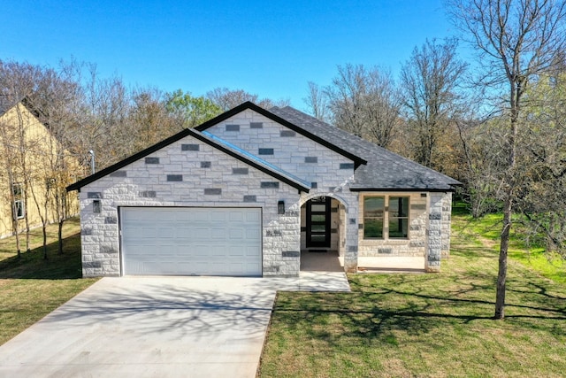 view of front of home with a garage and a front lawn