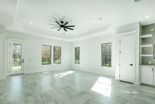 unfurnished room featuring crown molding, a tray ceiling, and ceiling fan