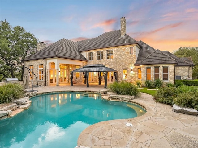 3844 Hunterwood Pt, Austin, TX 78746 - pool at dusk featuring a gazebo, a patio, and an outdoor pool