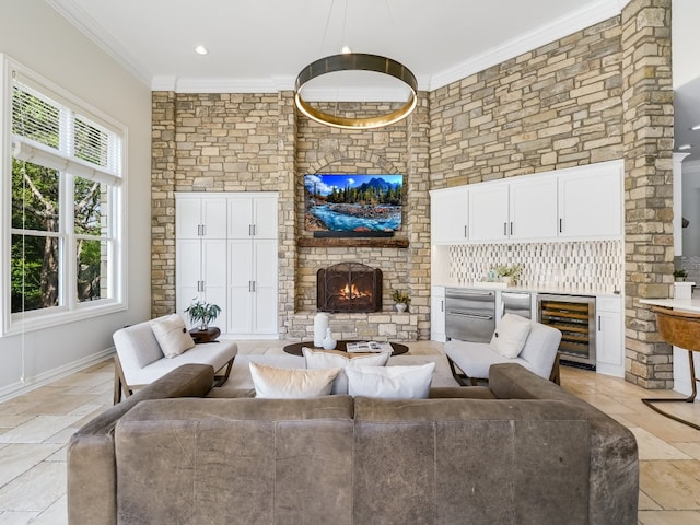 living room with crown molding, a brick fireplace, and wine cooler