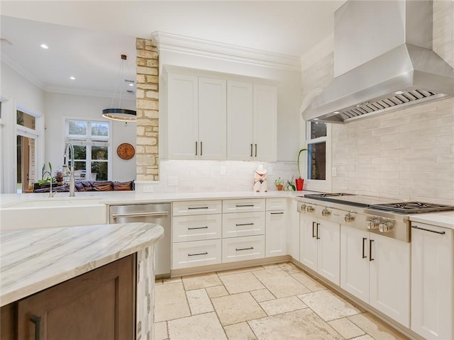 3844 Hunterwood Pt, Austin, TX 78746 - kitchen with wall chimney range hood, stainless steel appliances, backsplash, crown molding, and white cabinetry