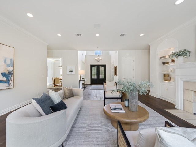 3844 Hunterwood Pt, Austin, TX 78746 - living area with wood finished floors, a chandelier, recessed lighting, crown molding, and a fireplace