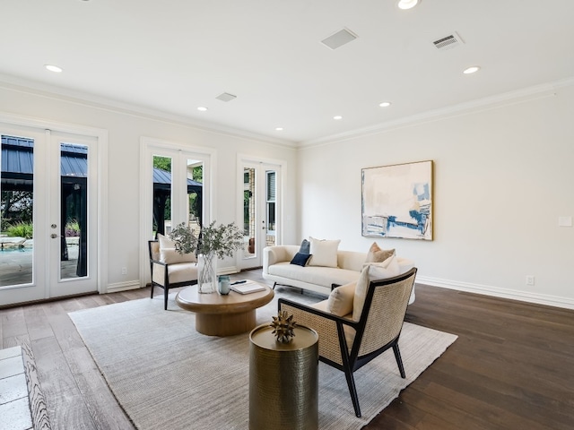 living room featuring dark hardwood / wood-style flooring, crown molding, and french doors