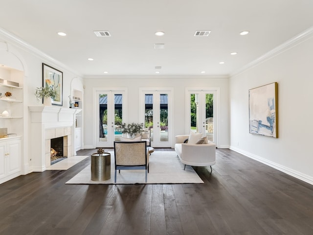 living room with dark hardwood / wood-style flooring, ornamental molding, and french doors