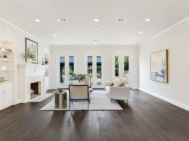 3844 Hunterwood Pt, Austin, TX 78746 - living area with french doors, dark wood finished floors, ornamental molding, a high end fireplace, and recessed lighting
