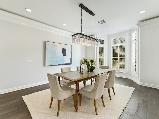 dining room with crown molding and dark hardwood / wood-style flooring