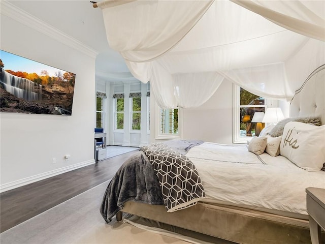 bedroom with hardwood / wood-style flooring and ornamental molding