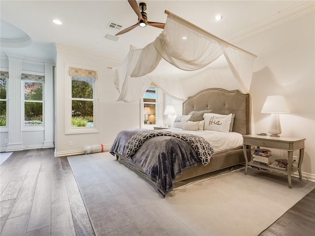 bedroom with wood-type flooring, ornamental molding, and ceiling fan