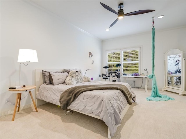 carpeted bedroom with crown molding and ceiling fan