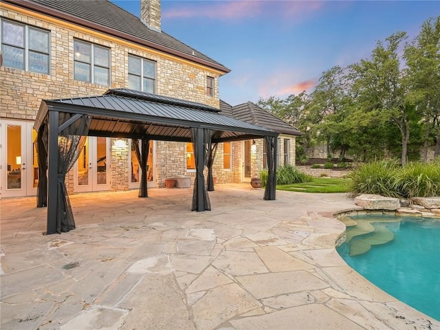 exterior space featuring a gazebo, a swimming pool, and a patio area