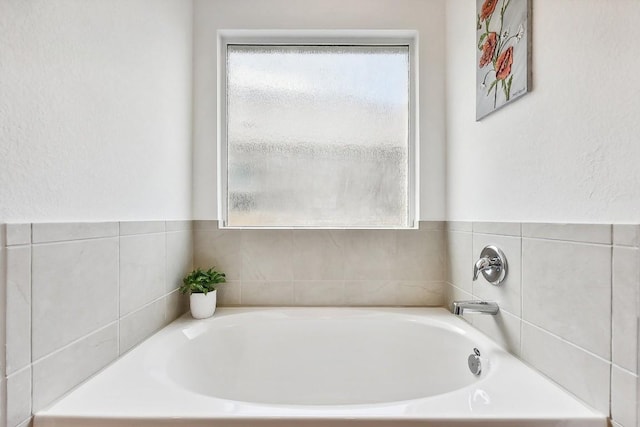 bathroom featuring a washtub and plenty of natural light